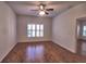 Bright bedroom with wood floors, shutters, and a ceiling fan at 201 Walter Stevens Way, Deland, FL 32724