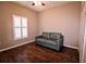 Bedroom with wood floors, a window with shutters, closet, and a loveseat at 201 Walter Stevens Way, Deland, FL 32724