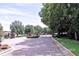 Gated community entrance with brick pillars, wrought iron gates and mature trees lining the brick road at 201 Walter Stevens Way, Deland, FL 32724