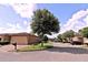 Beige home with a large garage, brick driveway, well maintained lawn, and mature trees at 201 Walter Stevens Way, Deland, FL 32724