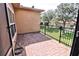 Outdoor patio area with brick flooring and wrought iron fence overlooking a green lawn at 201 Walter Stevens Way, Deland, FL 32724