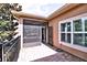 View of a screened lanai next to an outdoor patio with brick flooring and a lush green tree at 201 Walter Stevens Way, Deland, FL 32724