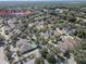 Aerial view of home near a pool and tennis courts at 202 W Chancery Ln, Deland, FL 32724