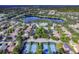 Community aerial view of the tennis courts and lake at 202 W Chancery Ln, Deland, FL 32724