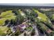 An aerial view showcasing a clubhouse and surrounding lush golf course of the community at 202 W Chancery Ln, Deland, FL 32724