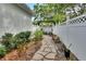 Backyard featuring a stone walkway and a white fence surrounding the yard at 202 W Chancery Ln, Deland, FL 32724