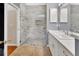 Beautiful bathroom featuring marble tile in the walk-in shower and white cabinets at 202 W Chancery Ln, Deland, FL 32724