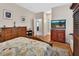 Spacious bedroom with hardwood floors, a dresser, and a view to the bathroom at 202 W Chancery Ln, Deland, FL 32724