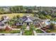 Aerial view of clubhouse featuring manicured lawns, palm trees, and a paved walkway at 202 W Chancery Ln, Deland, FL 32724