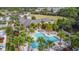 Aerial view of resort style community pool with palm trees and lounge chairs for relaxing outdoors at 202 W Chancery Ln, Deland, FL 32724