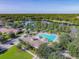Aerial view of a lake near a community pool and clubhouse at 202 W Chancery Ln, Deland, FL 32724