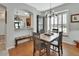 Dining area with hardwood flooring, large windows, and an open view into the kitchen at 202 W Chancery Ln, Deland, FL 32724