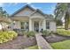 Charming single-story home with well-manicured landscaping, inviting front porch, and a welcoming walkway at 202 W Chancery Ln, Deland, FL 32724