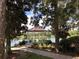 Waterside gazebo surrounded by manicured landscaping and mature trees, with benches for residents at 202 W Chancery Ln, Deland, FL 32724