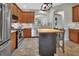 Bright kitchen with stainless appliances, wood cabinets, mosaic backsplash, and butcher block island at 202 W Chancery Ln, Deland, FL 32724