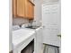 Laundry room with a white washer and dryer and wood cabinets at 202 W Chancery Ln, Deland, FL 32724