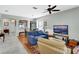Comfortable living room with neutral walls, tile and hardwood floors, and a seamless transition into dining area at 202 W Chancery Ln, Deland, FL 32724