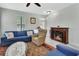 Cozy living room featuring a fireplace, comfortable seating, and an abundance of natural light at 202 W Chancery Ln, Deland, FL 32724