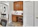 Cozy office nook with built in desk and cabinetry adjacent to the kitchen at 202 W Chancery Ln, Deland, FL 32724