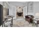 Sun room featuring tile flooring, modern furniture, and open access to kitchen at 202 W Chancery Ln, Deland, FL 32724
