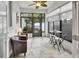 Bright sun room with tile flooring, ceiling fan, and backyard views at 202 W Chancery Ln, Deland, FL 32724