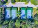 Aerial view of the community's tennis courts with blue and green surfaces bordered by green trees at 202 W Chancery Ln, Deland, FL 32724