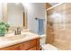 Bathroom featuring a tiled shower, granite vanity and decorated mirror at 2127 3Rd Ave, Deland, FL 32724