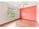 Inviting bedroom with hardwood floors, large window, and bright natural lighting at 2127 3Rd Ave, Deland, FL 32724