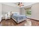 Bedroom features wood floors, ceiling fan, natural light, and a cozy atmosphere at 2127 3Rd Ave, Deland, FL 32724