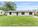 Charming single-story home with white exterior, green lawn, and well-maintained landscaping at 2127 3Rd Ave, Deland, FL 32724