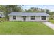 Charming single-story home featuring a well-maintained lawn and a classic facade at 2127 3Rd Ave, Deland, FL 32724