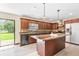 Kitchen with dark cabinetry, an island, and stainless steel appliances, perfect for cooking and entertaining at 2127 3Rd Ave, Deland, FL 32724
