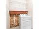 Bright laundry room with white dryer, shelving, and under-shelf wood accent at 2127 3Rd Ave, Deland, FL 32724