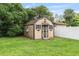 Backyard shed with double doors, side windows, and a neutral painted exterior at 2127 3Rd Ave, Deland, FL 32724