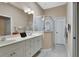 Bathroom with dual sinks, mirror, and glass door shower at 217 Lourdan Ct, Debary, FL 32713