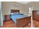 Comfortable bedroom featuring wood floors and a view to the ensuite bathroom at 217 Lourdan Ct, Debary, FL 32713