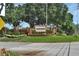 Debary Golf & Country Club entrance with brick signage, lush landscaping, and manicured grounds at 217 Lourdan Ct, Debary, FL 32713