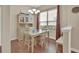 Bright dining area features a table and chairs, cabinet, and a large window at 217 Lourdan Ct, Debary, FL 32713