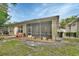Back exterior view of the home showing the screened-in lanai and backyard at 217 Lourdan Ct, Debary, FL 32713