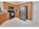 Functional kitchen features wood cabinets, modern appliances, and ample counter space at 217 Lourdan Ct, Debary, FL 32713