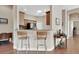 Open kitchen features a breakfast bar, wood cabinets, and black appliances at 217 Lourdan Ct, Debary, FL 32713