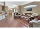 Open living room features hardwood floors, comfortable seating, and an adjacent dining area at 217 Lourdan Ct, Debary, FL 32713