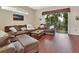 Comfortable living room boasts hardwood floors, a large sectional sofa, and natural light at 217 Lourdan Ct, Debary, FL 32713