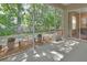 Inviting screened-in patio with potted plants and a view of the backyard at 217 Lourdan Ct, Debary, FL 32713