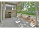 Relaxing screened-in patio with a grill and view of the landscaped yard at 217 Lourdan Ct, Debary, FL 32713