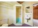 Functional bathroom with a toilet, sink, and walk-in shower, featuring retro yellow block walls and practical fixtures at 220 N Julia Ave, Deland, FL 32720