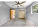 Neutral bedroom features carpeted floors, gray walls, ceiling fan, and closet at 220 N Julia Ave, Deland, FL 32720