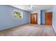 Bedroom featuring blue walls, carpet, ceiling fan, closet, and one window at 220 N Julia Ave, Deland, FL 32720