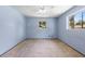 Bedroom featuring blue walls, carpet, ceiling fan, and two windows at 220 N Julia Ave, Deland, FL 32720