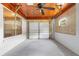 Spacious garage with painted block walls, ample lighting, a window, and a multi-panel door at 220 N Julia Ave, Deland, FL 32720